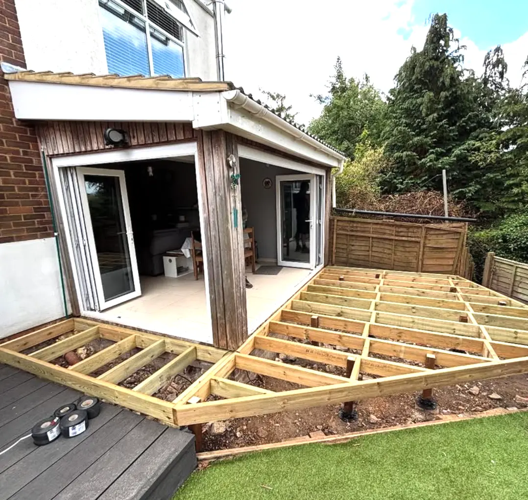 New timber decking subframe being built around a garden room