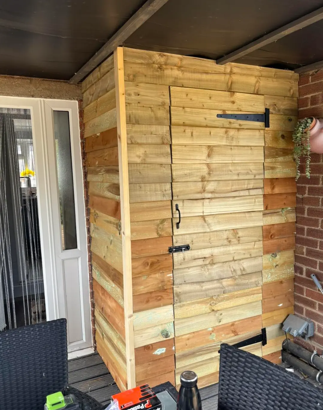 Bespoke feather-edge timber garden store with ledged door