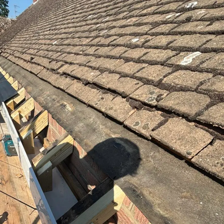 Roof carpentry: new rafter feet and fascia board fitted from scaffolding